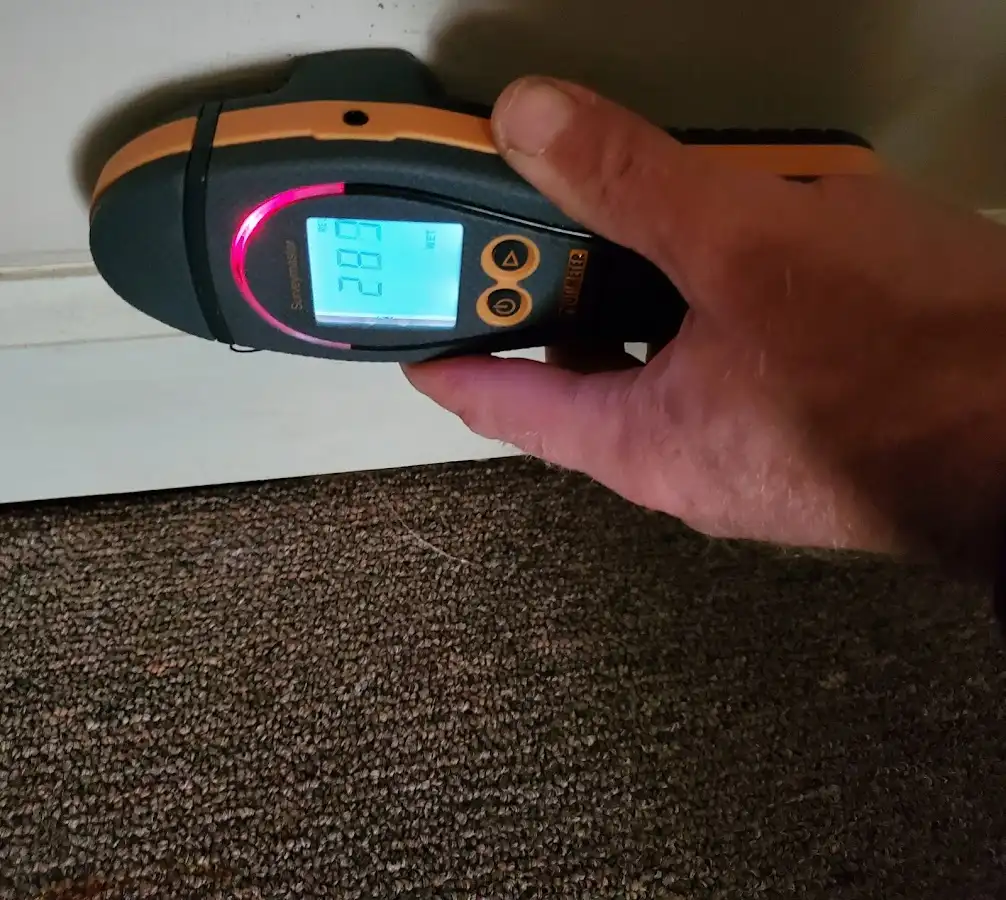 Moisture detection at baseboard during Storm Damage Restoration in Texarkana